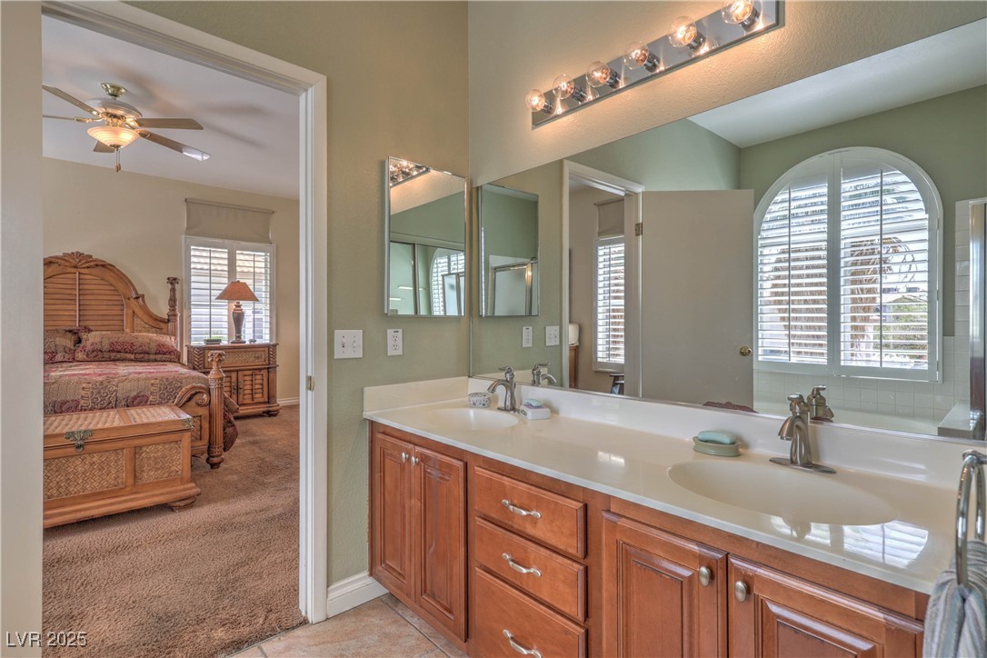 8325 Alta Drive Las Vegas, NV 89145 - Photo 19 of 31 Ensuite bathroom featuring double vanity, light tile patterned floors, and a ceiling fan