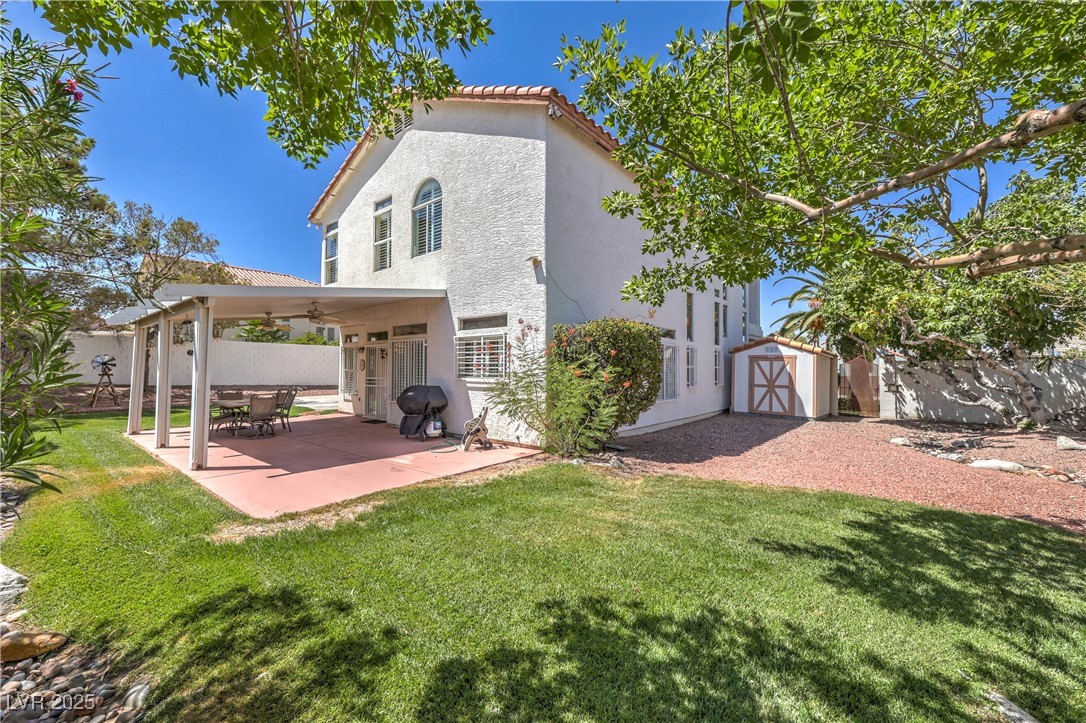 8325 Alta Drive Las Vegas, NV 89145 - Photo 26 of 31 Rear view of property featuring, a pool size yard, a shed, and a patio area