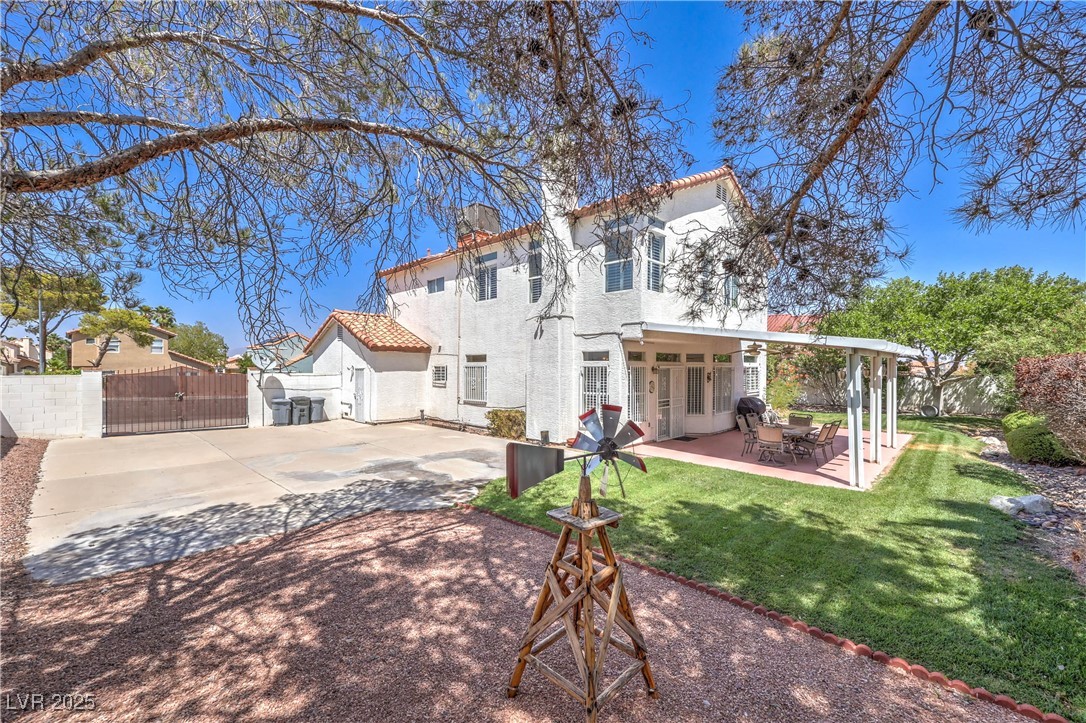 8325 Alta Drive Las Vegas, NV 89145 - Photo 31 of 31 Rear view of house featuring a fenced backyard, and a patio