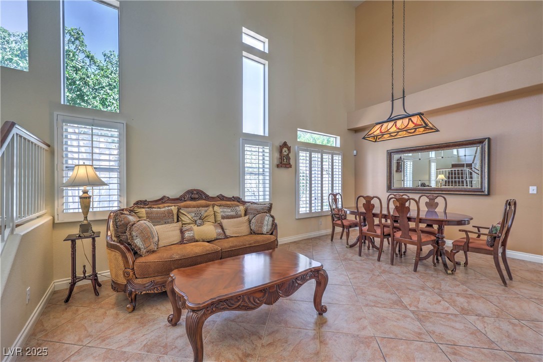 8325 Alta Drive Las Vegas, NV 89145 - Photo 6 of 31 Living room featuring a towering ceiling and light tile patterned flooring