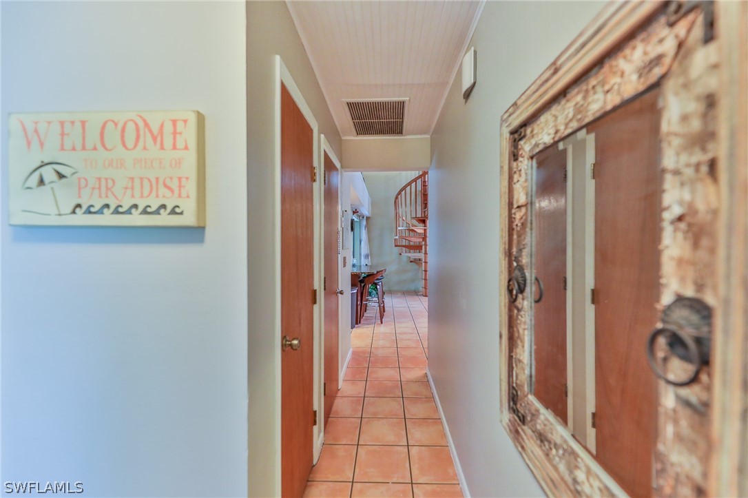7213 Myrtle Road Fort Myers, FL 33967 - Photo 11 of 35 a view of hallway with a door and furniture