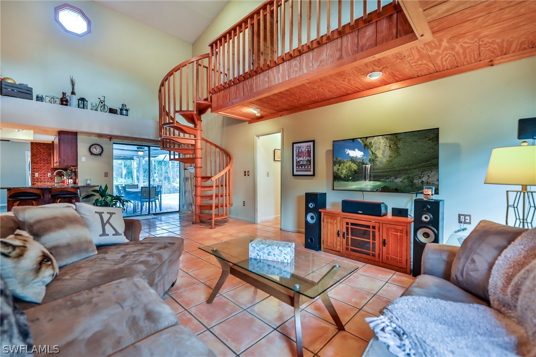 7213 Myrtle Road Fort Myers, FL 33967 - Photo 13 of 35 a living room with furniture a flat screen tv and a table