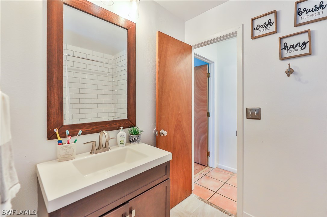 7213 Myrtle Road Fort Myers, FL 33967 - Photo 16 of 35 a bathroom with a sink and a mirror