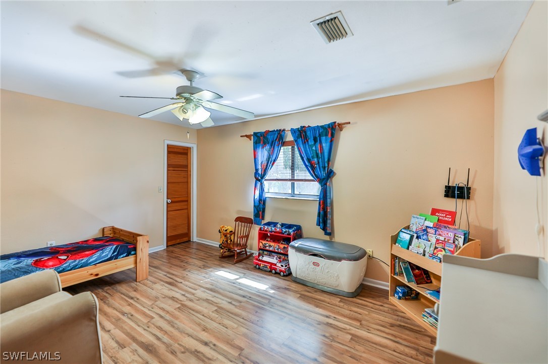 7213 Myrtle Road Fort Myers, FL 33967 - Photo 19 of 35 a living room with furniture and a wooden floor