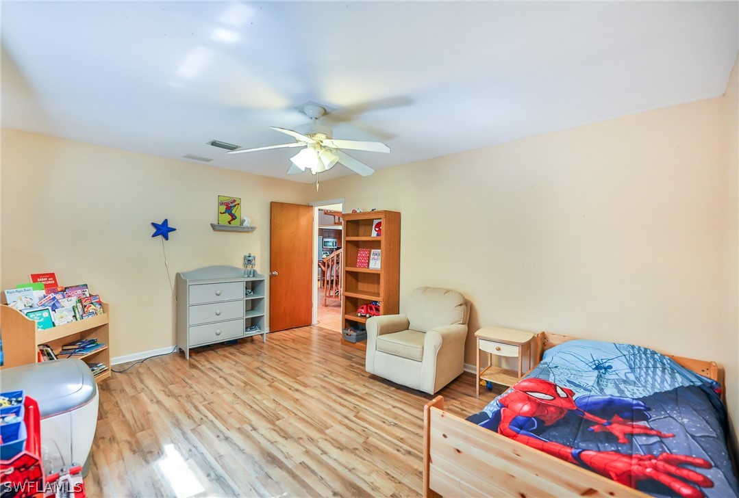 7213 Myrtle Road Fort Myers, FL 33967 - Photo 20 of 35 a bedroom with furniture and a wooden floor
