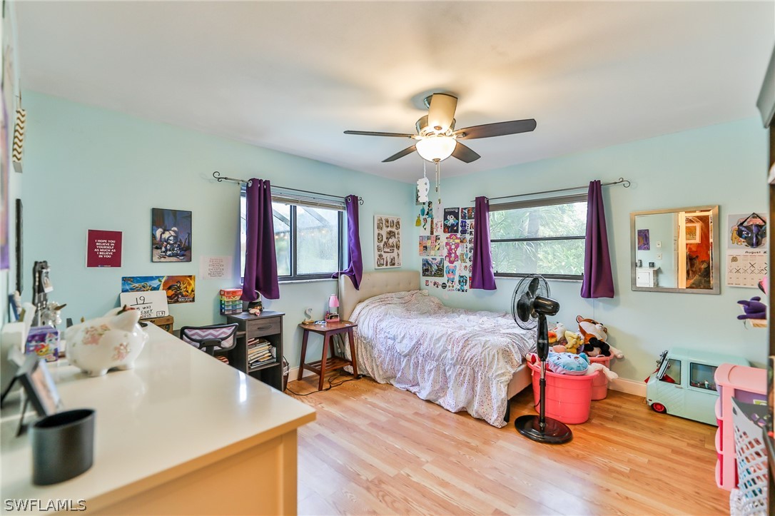 7213 Myrtle Road Fort Myers, FL 33967 - Photo 21 of 35 a bedroom with a bed and a chandelier