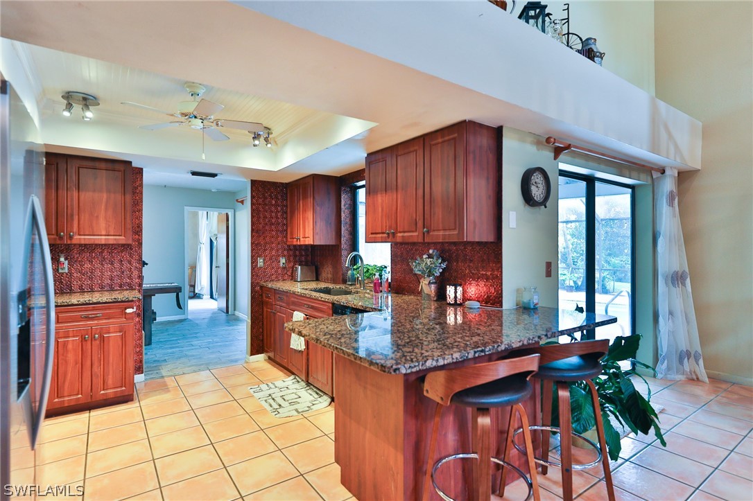 7213 Myrtle Road Fort Myers, FL 33967 - Photo 22 of 35 a kitchen with granite countertop a stove refrigerator and cabinets