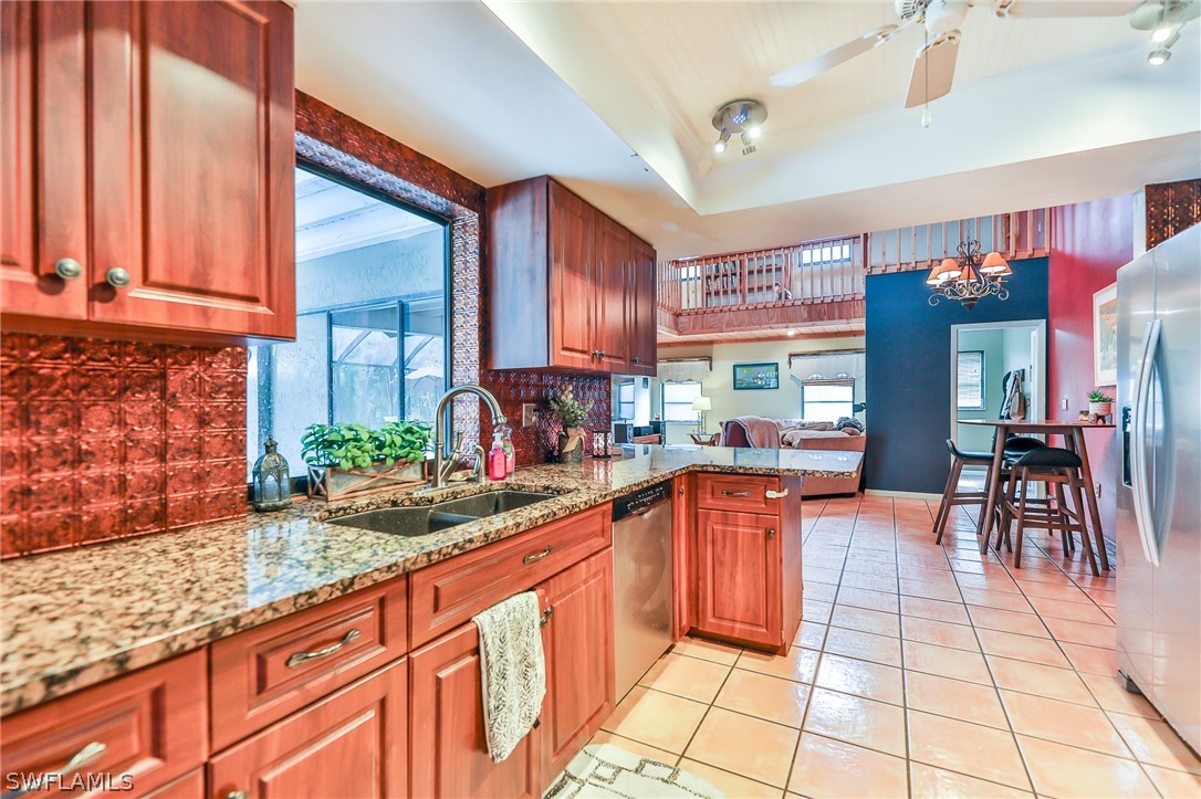 7213 Myrtle Road Fort Myers, FL 33967 - Photo 23 of 35 a kitchen with stainless steel appliances granite countertop sink stove and cabinets