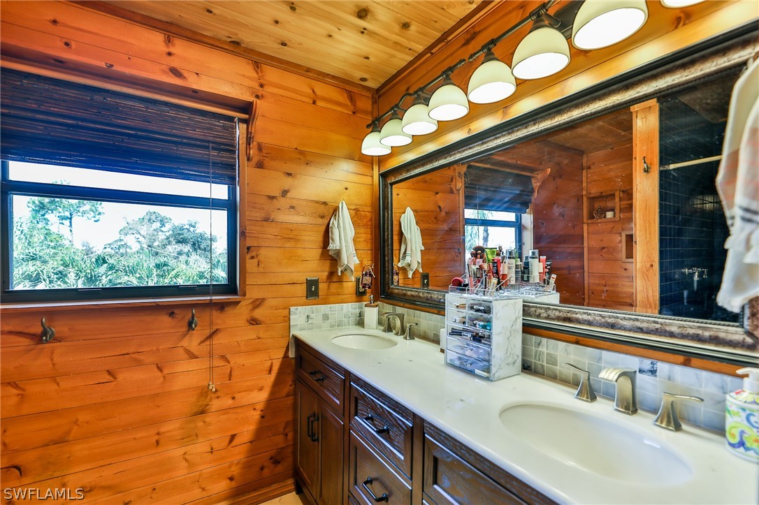 7213 Myrtle Road Fort Myers, FL 33967 - Photo 25 of 35 a bathroom with a sink and a large mirror