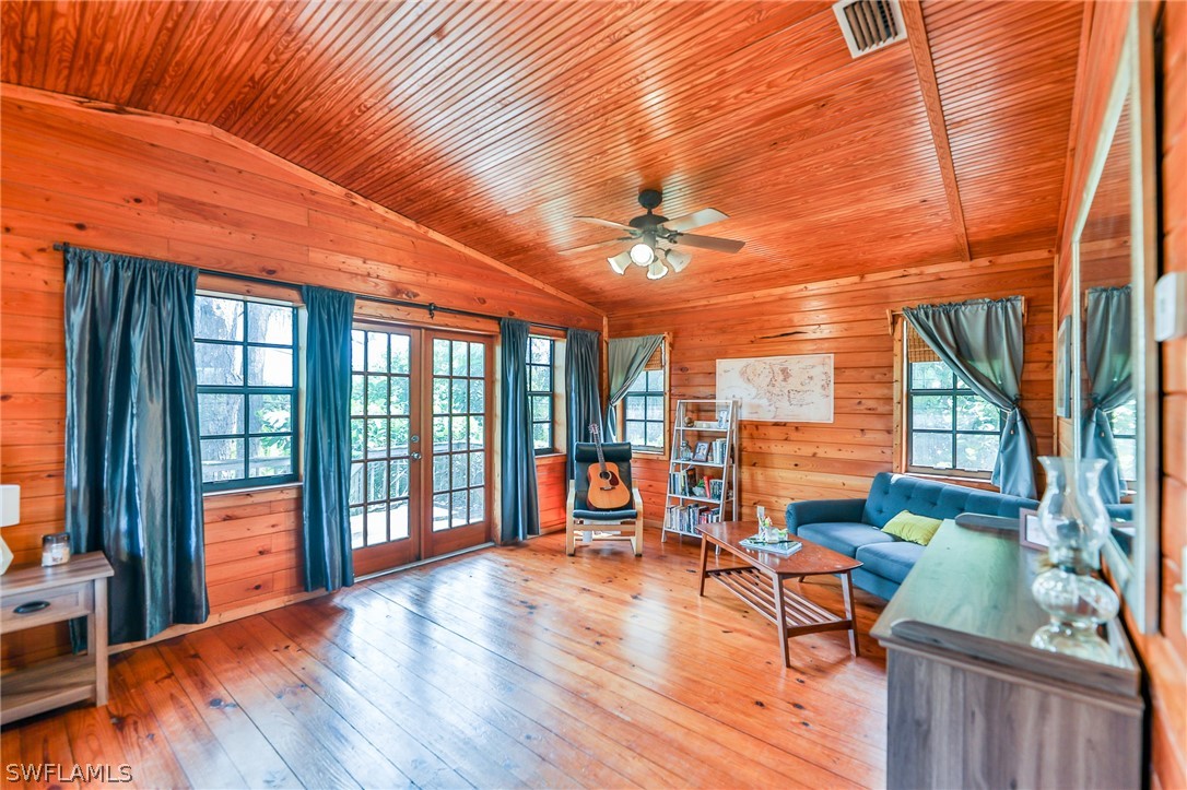 7213 Myrtle Road Fort Myers, FL 33967 - Photo 26 of 35 a view of a porch with furniture and wooden floor
