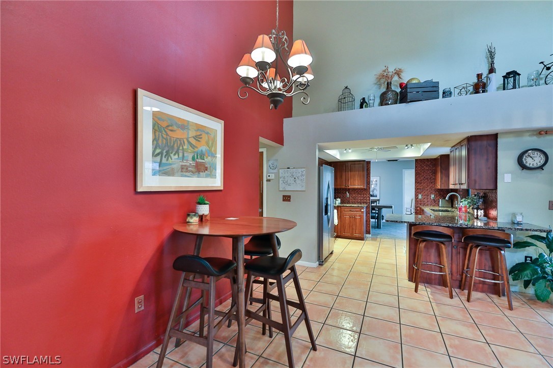 7213 Myrtle Road Fort Myers, FL 33967 - Photo 8 of 35 a view of a dining room with furniture and chandelier
