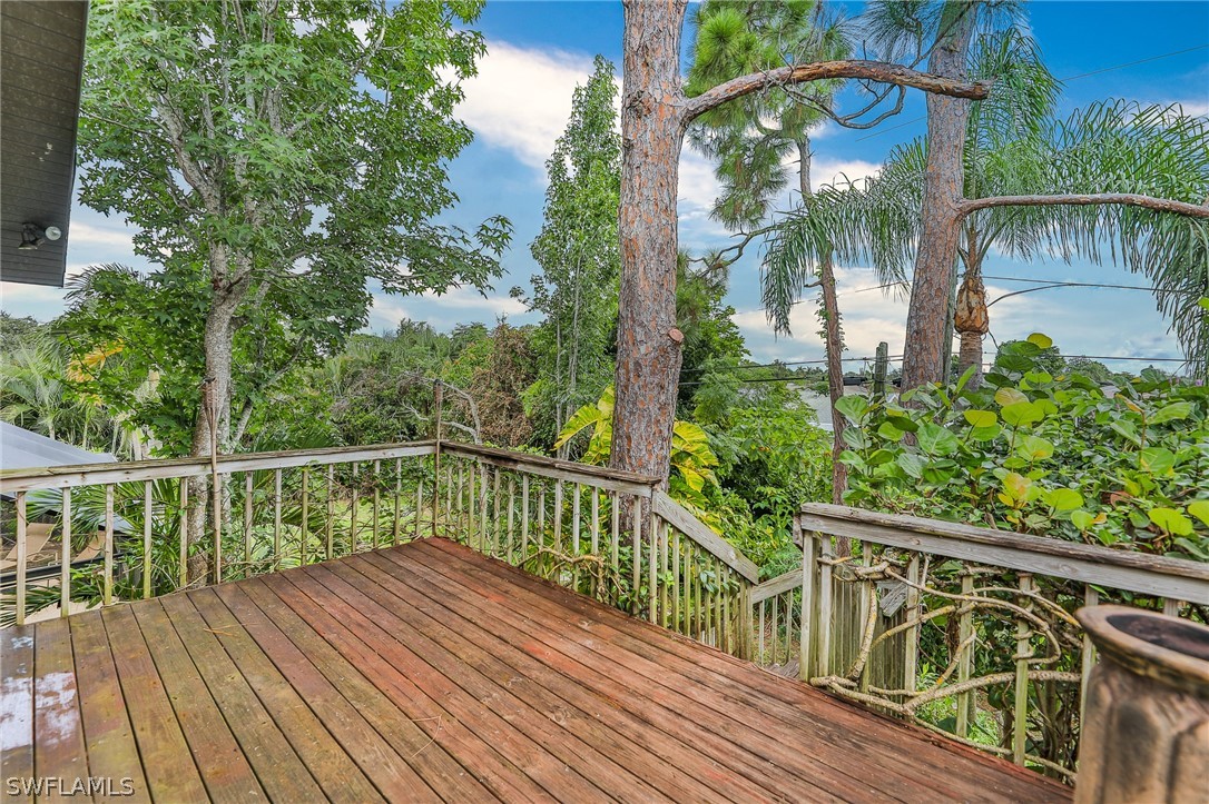 7213 Myrtle Road Fort Myers, FL 33967 - Photo 9 of 35 a view of balcony with wooden floor and fence