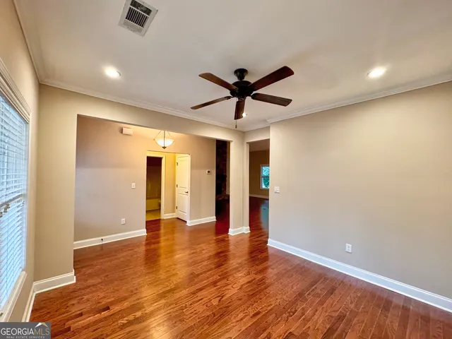 wooden floor in an empty room with a window