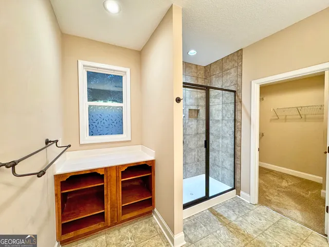 a spacious bathroom with a double vanity sink mirror and toilet