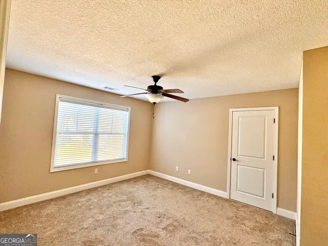 a view of a livingroom with a chandelier fan