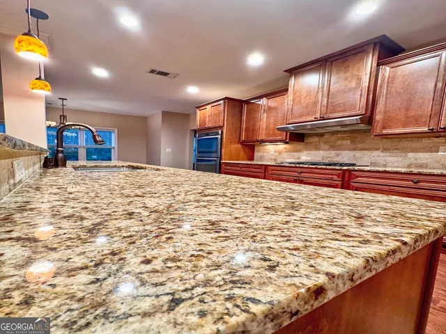 a view of a kitchen with a sink and cabinets
