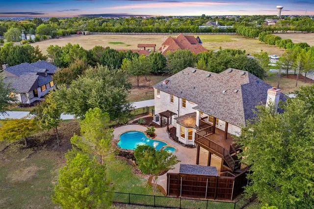 an aerial view of a house with a lake view