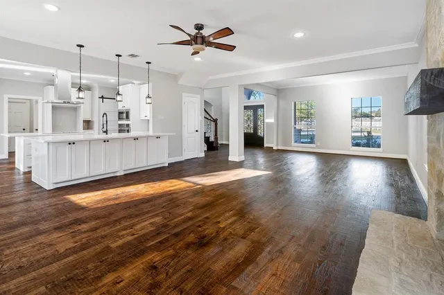a view of a living room a kitchen with wooden floor and window