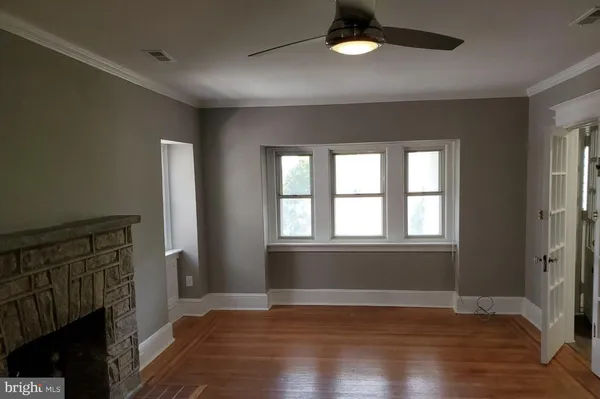 wooden floor in an empty room with a window