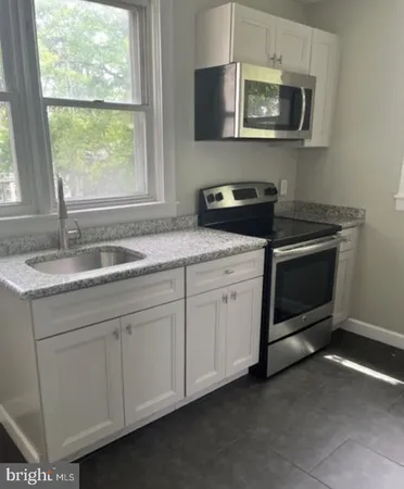 a kitchen with a stove and a sink