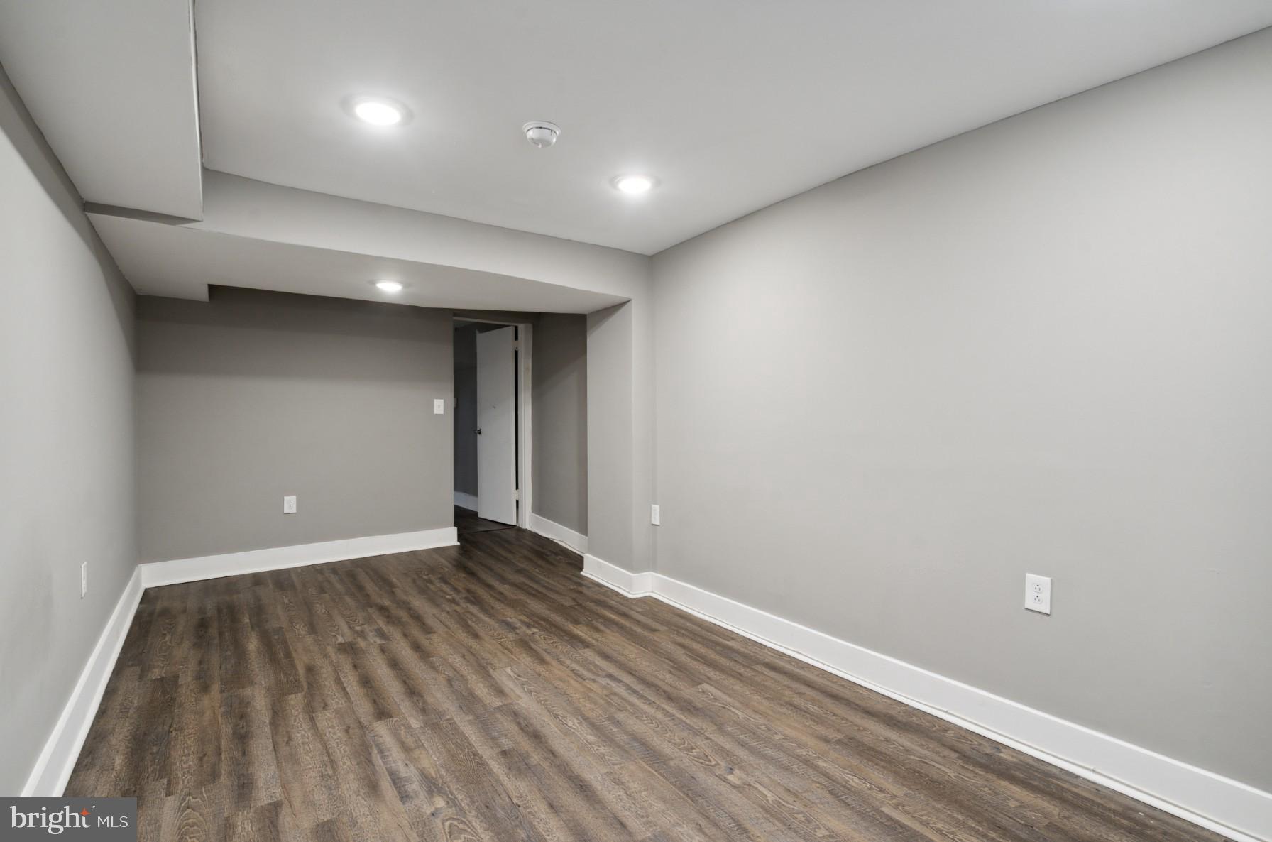 38 Copley Road Upper Darby, PA 19082 - Photo 20 of 22 an empty room with wooden floor and natural light