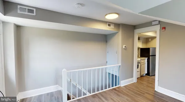 a view of hallway with wooden floor