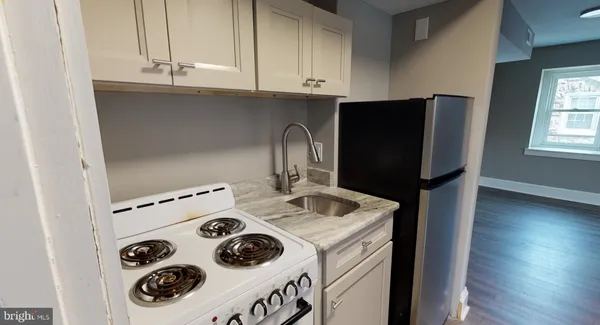 a kitchen with a sink and a refrigerator