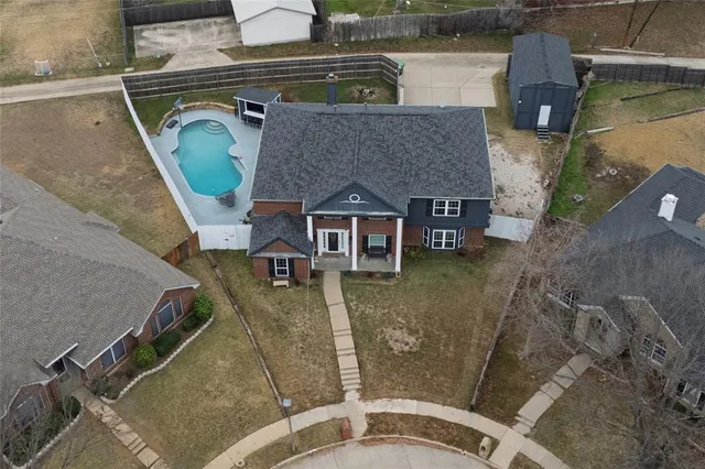 an aerial view of a house with a yard