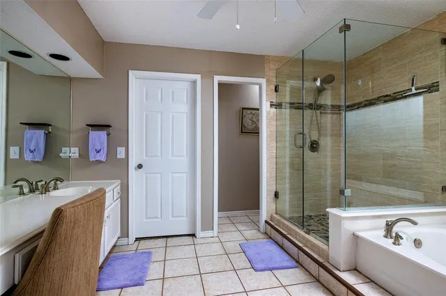 a bathroom with a tub shower and sink