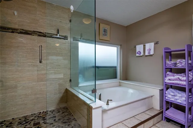 a bathroom with a tub and a shower