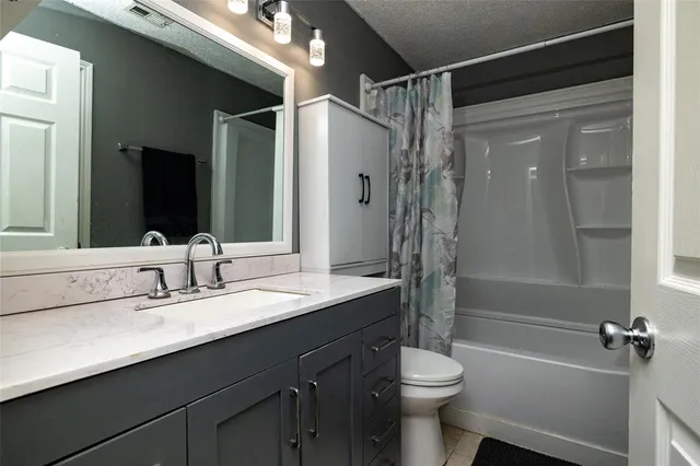 a bathroom with a double vanity sink toilet mirror and shower
