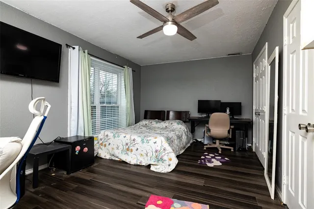 a bedroom with bed tv and window