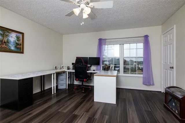 a view of a workspace with furniture and a window