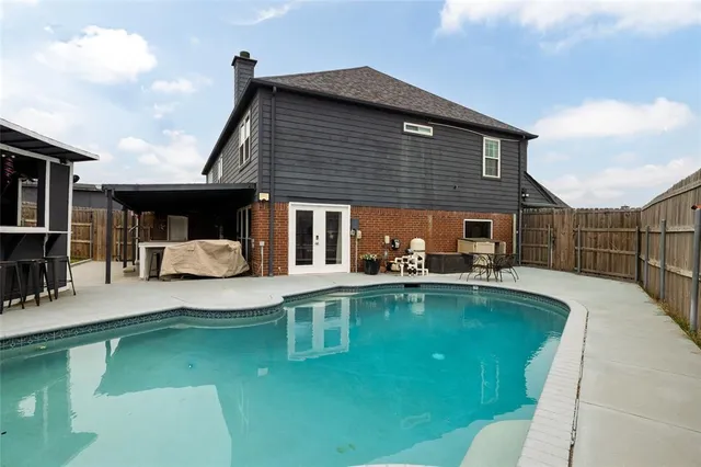a view of a swimming pool with a patio