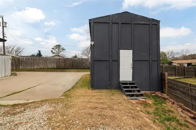 a view of a house with wooden fence
