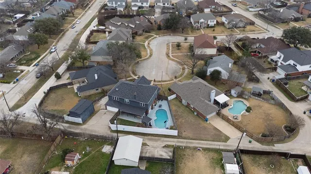 an aerial view of residential houses with outdoor space