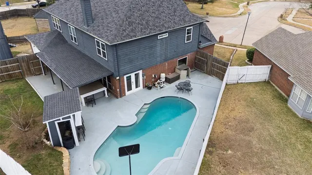 swimming pool view with a seating space