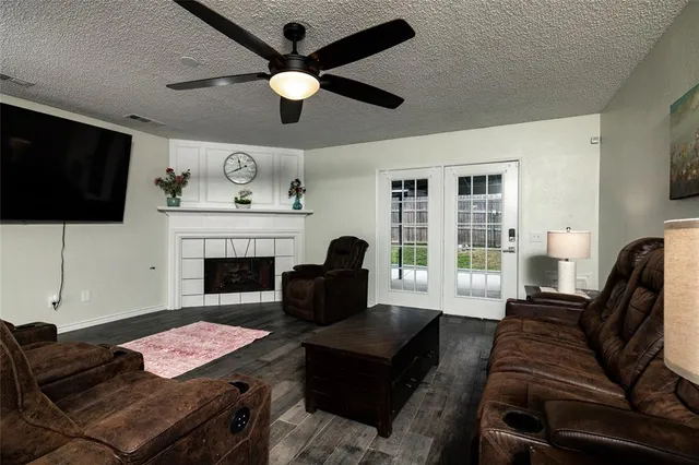 a living room with furniture a flat screen tv and a fireplace