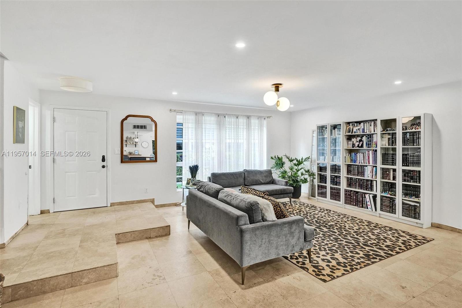1165 99th Street, Unit 2 Bay Harbor Islands, FL 33154 - Photo 4 of 10 a living room with furniture and a large window