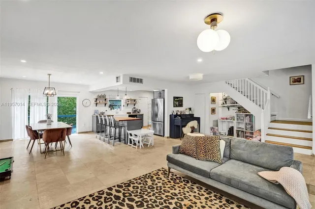 a living room with furniture and kitchen view