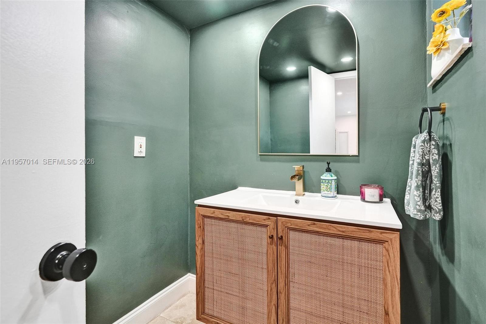 1165 99th Street, Unit 2 Bay Harbor Islands, FL 33154 - Photo 9 of 10 a bathroom with a sink and a mirror