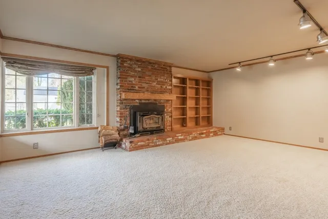 an empty room with furniture and a fireplace