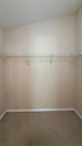 an empty room with wooden floor and door