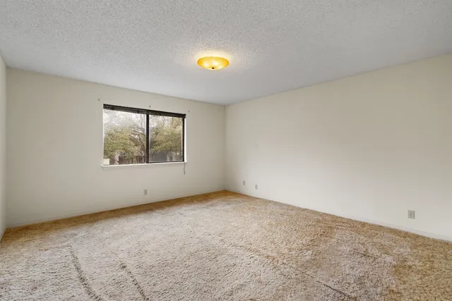 an empty room with a empty space and window