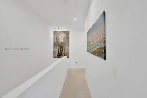 a view of a hallway with stairs