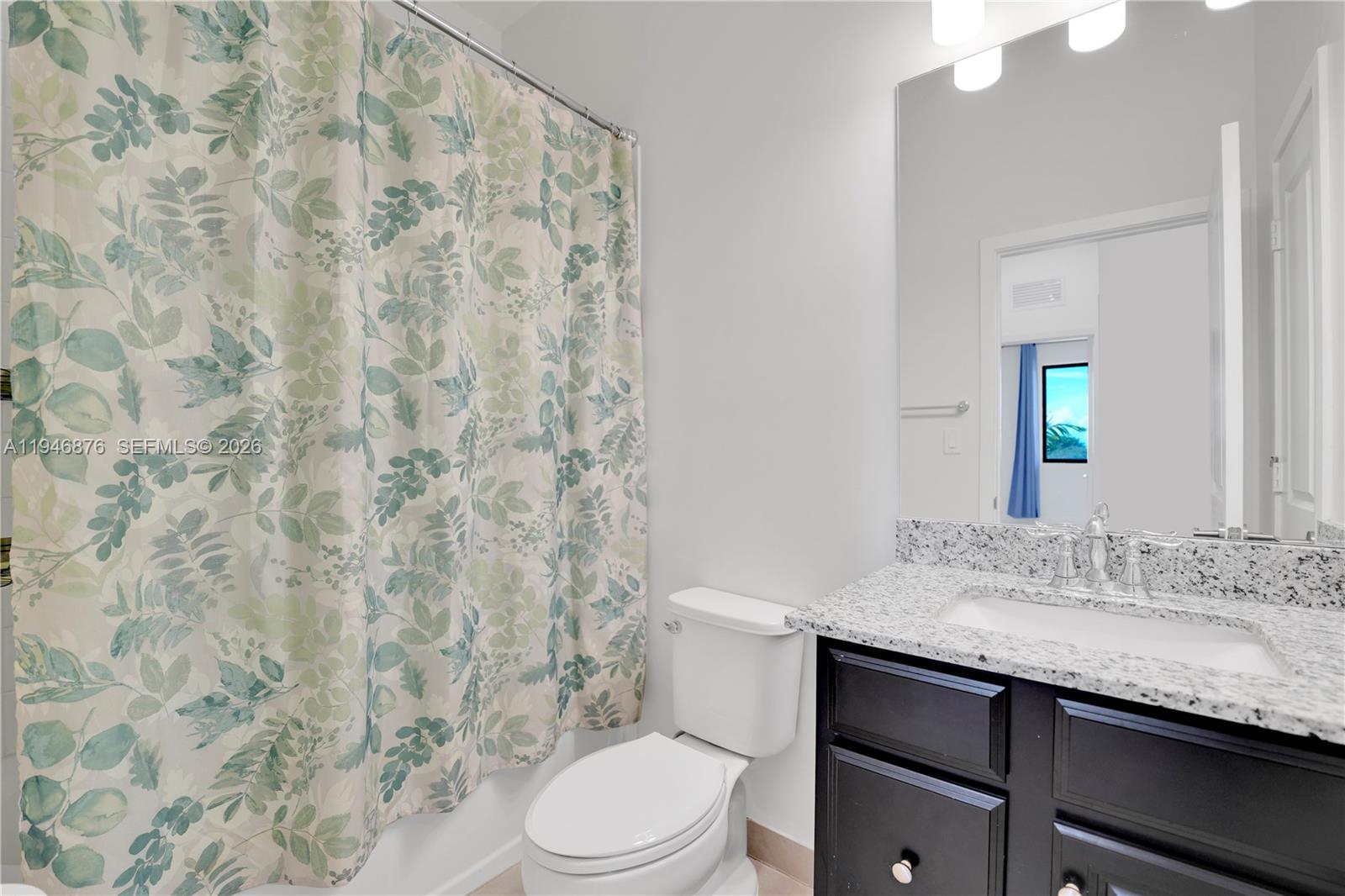 23302 Southwest 110th Avenue Homestead, FL 33032 - Photo 17 of 26 a bathroom with a granite countertop sink mirror vanity and toilet