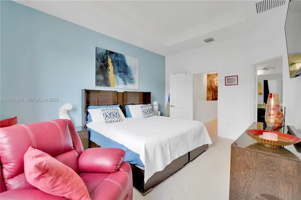 a bedroom with bed and a couch