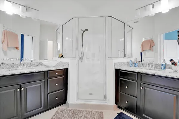 a bathroom with double vanity sink and a mirror