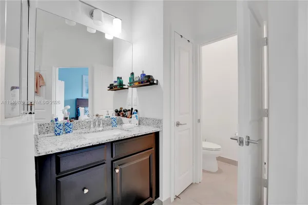 a bathroom with a sink a toilet and a mirror