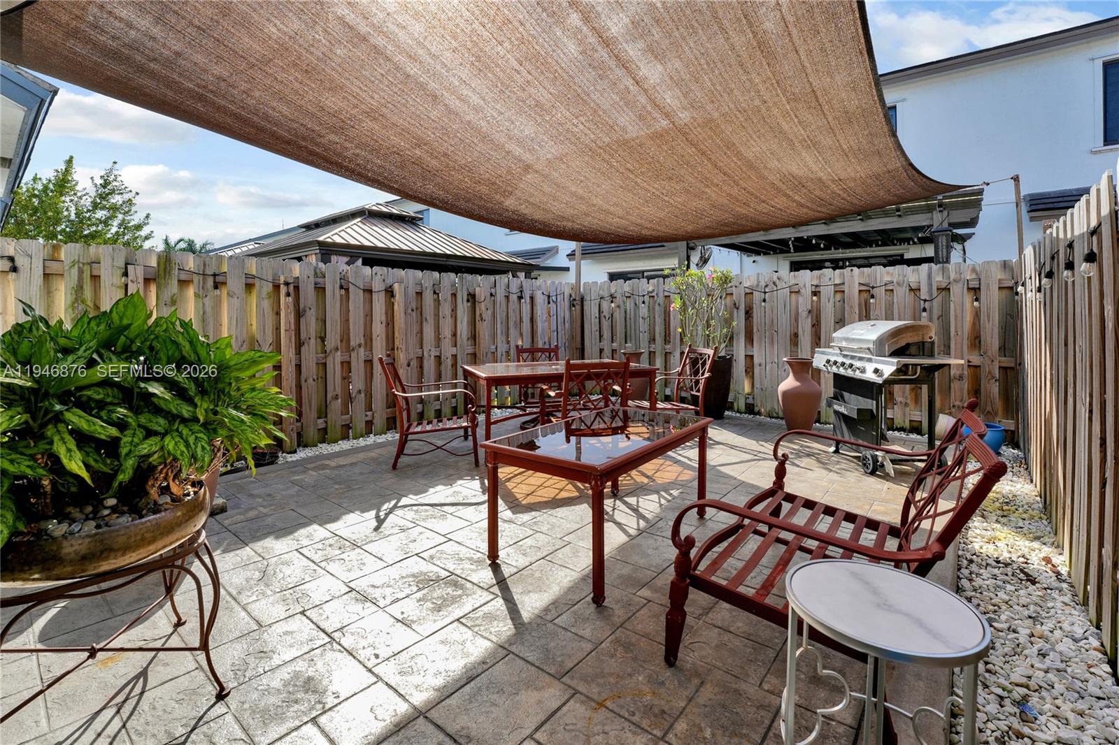 23302 Southwest 110th Avenue Homestead, FL 33032 - Photo 22 of 26 a backyard of a house with barbeque oven table and chairs